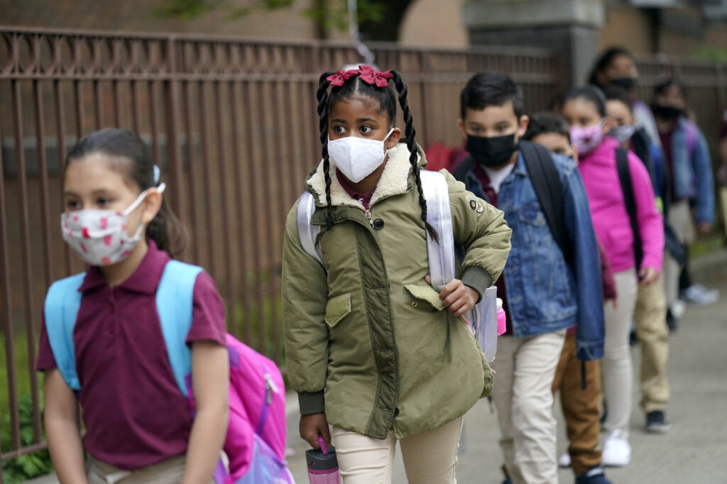 Virus Outbreak New Jersey Students line up to enter Christa McAuliffe School while wearing masks