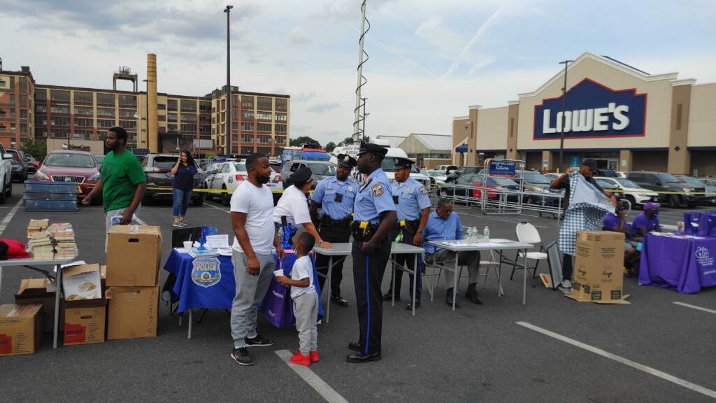 NNO_TM_080421_03 Marvin Ebron and son MJ speak to a police officer