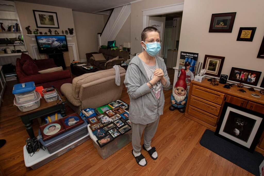 SPA_unemployment_benefits_080421 Stacey Horrocks stands inside her home wearing a face mask