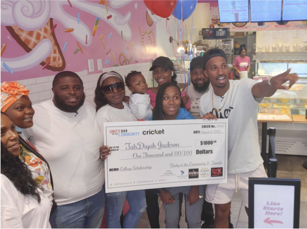Unity in the Community surprised TahDiyah Jackson and her mother Ameena with a $1,000 scholarship. (Tom MacDonald/WHYY)