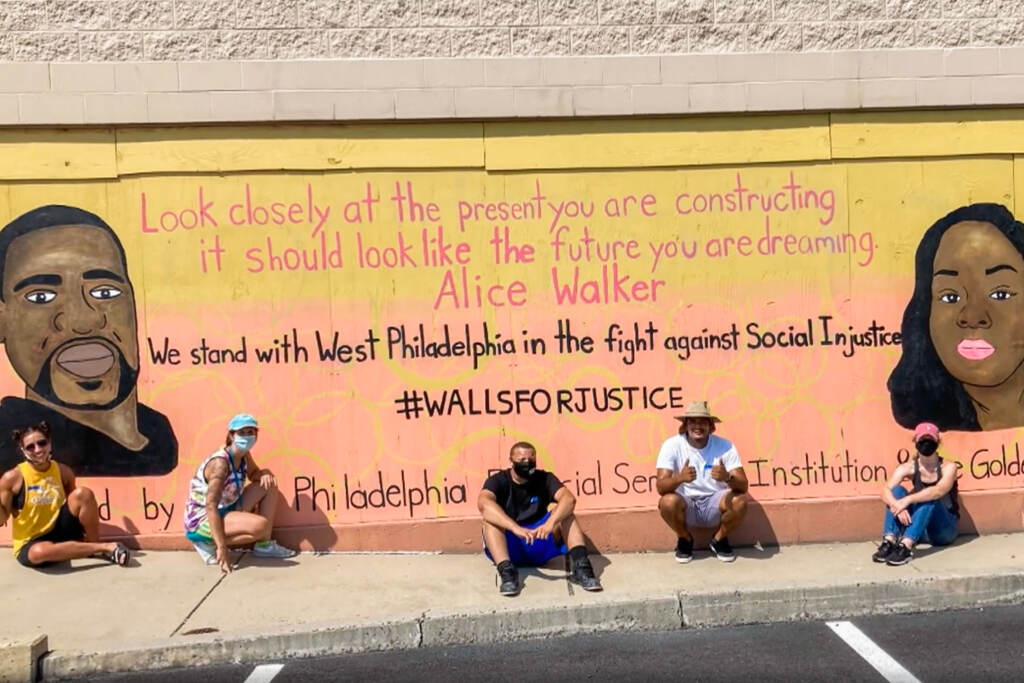 YCS-05-WEB Teenagers sitting in front of a mural with George Floyd and Breanna Taylor in support of Black Lives Matter