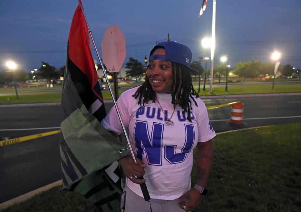 Lashay Alston holds a Black Lives Matter flag