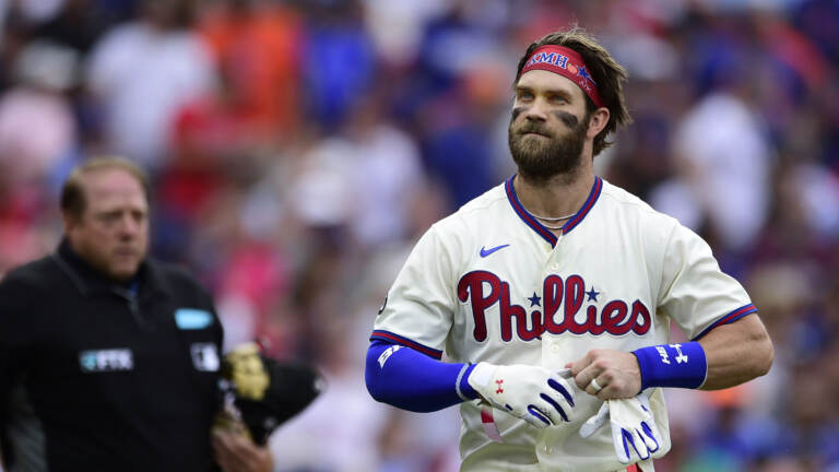Bryce Harper stands by home plate.