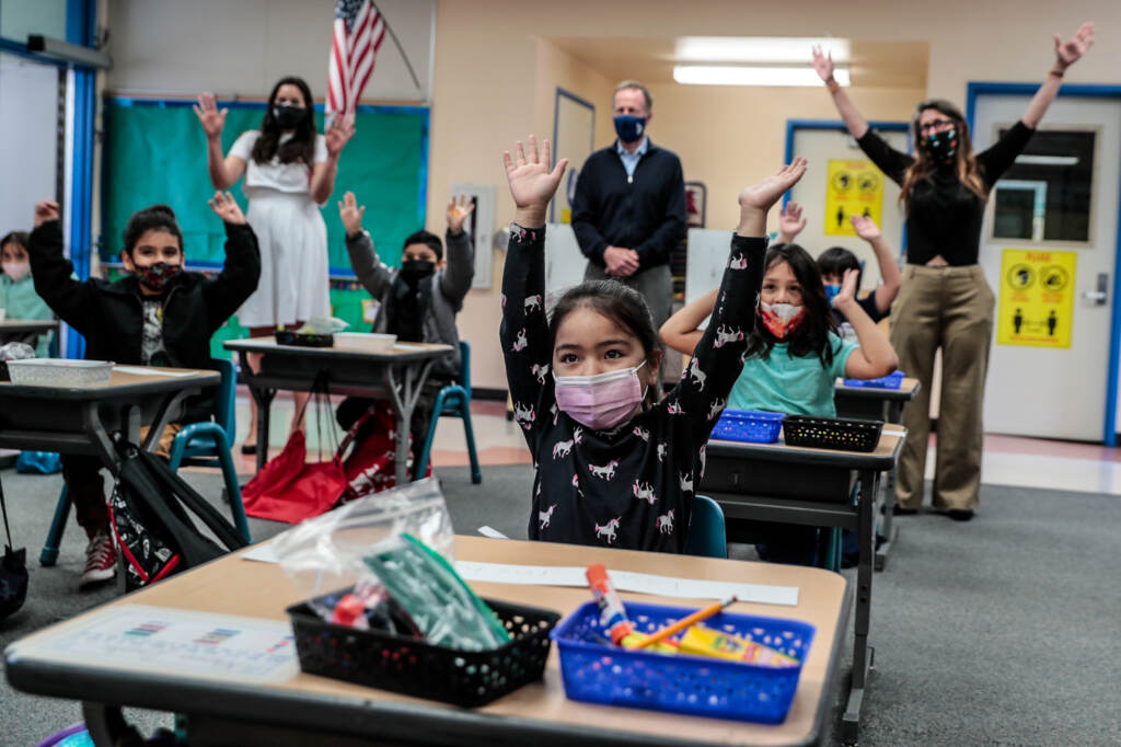 Kindergartner Allyson Zavala joined with other students and school superintendent Austin Buetner for a class selfie in April inside teacher Alicia Pizzi’s classroom at Maurice Sendak Elementary School in North Hollywood, Calif. Kindergarteners raise their hands while wearing face masks in a classroom