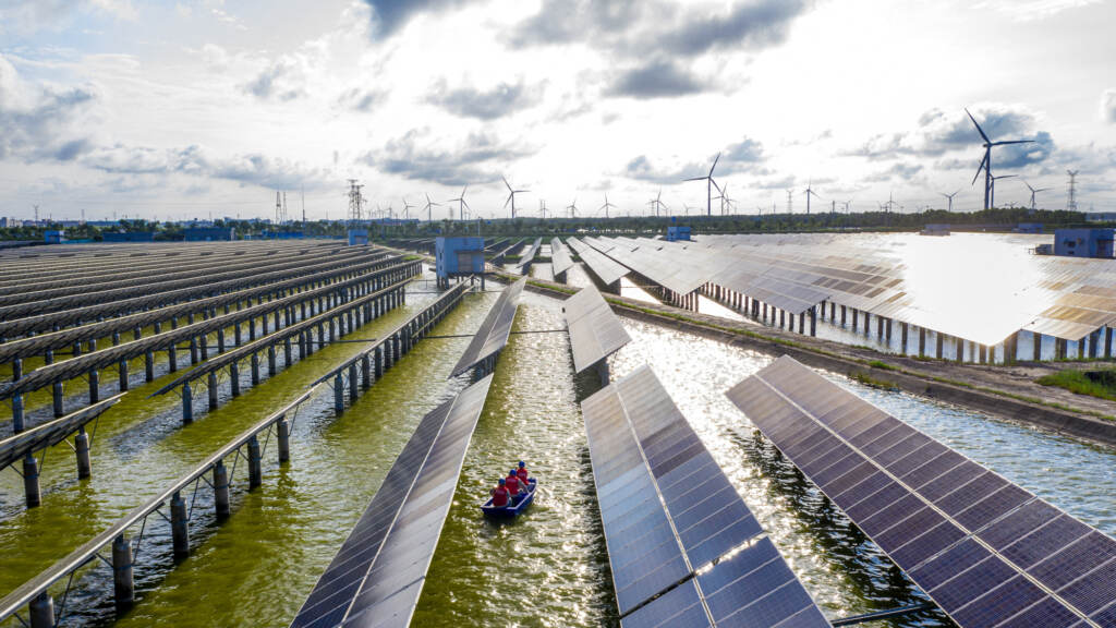 Electrical workers check solar panels at a photovoltaic power station built in a fishpond in Haian in China’s eastern Jiangsu province. Electrical workers check solar panels at a photovoltaic power station built in a fishpond in Haian in China's eastern Jiangsu province. (STR/AFP via Getty Images)