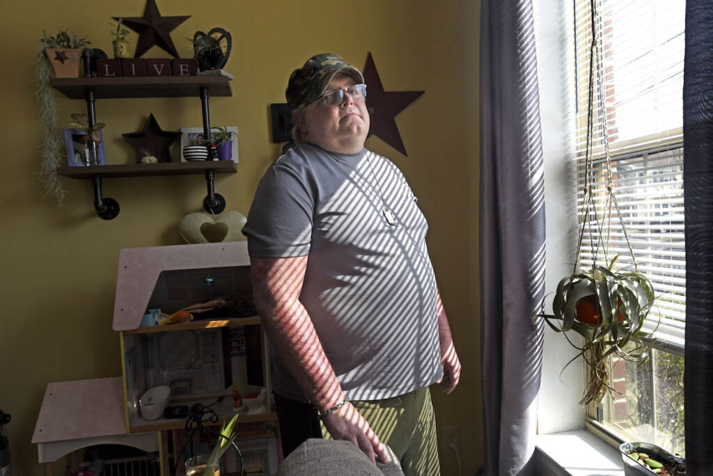 housing01 In Camden on August 6, Antioch Manor resident Don Brown stands at the window in his apartment; from it, he watched a murder take place earlier this year. (April Saul for WHYY)