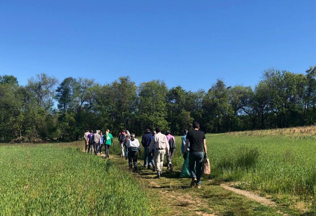 A group of volunteers hikes through a portion of White Clay Creek State Park