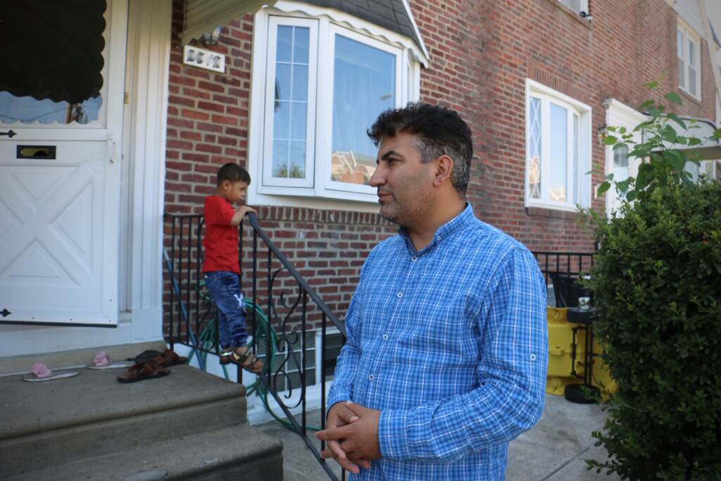 Mohammed Sadeed stands outside his home