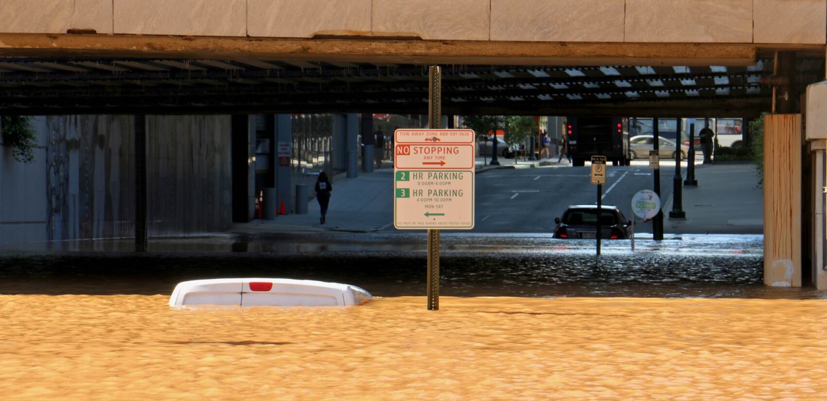 Vehicle is submerged in floodwater under the JFK Boulevard