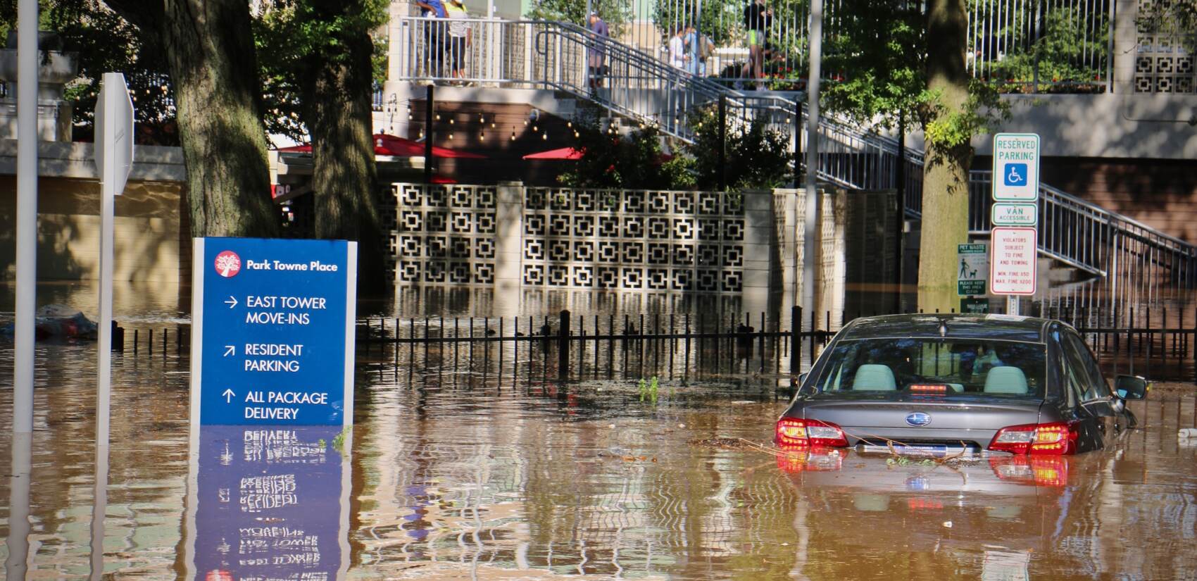 Vehicle is submerged in floodwater in Center City