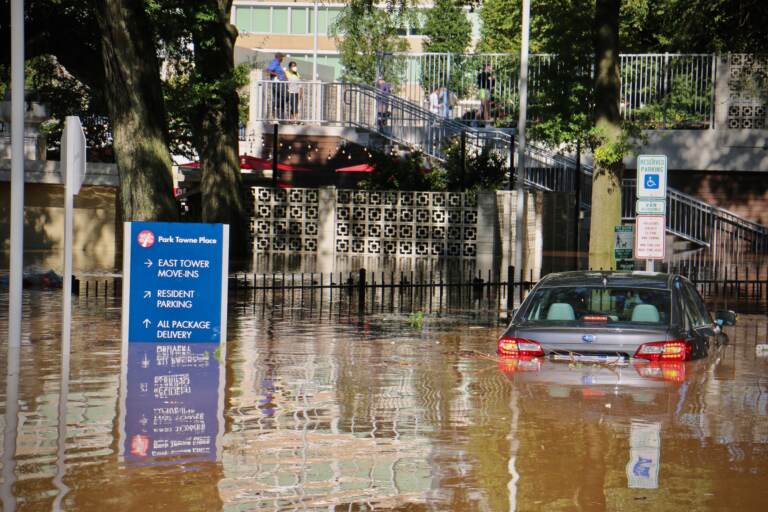 Vehicle is submerged in floodwater in Center City