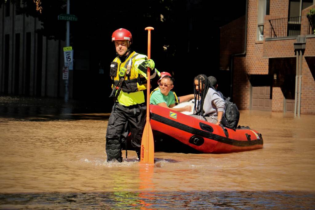 Fire Department rescue teams assist residents via raft