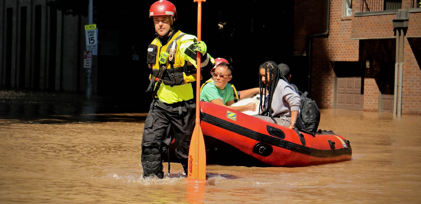 Fire Department rescue teams assist residents via raft