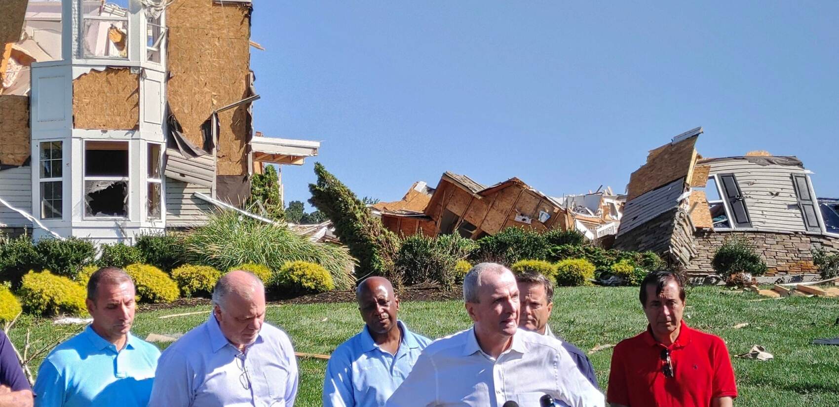 Gov. Phil Murphy stands with officials