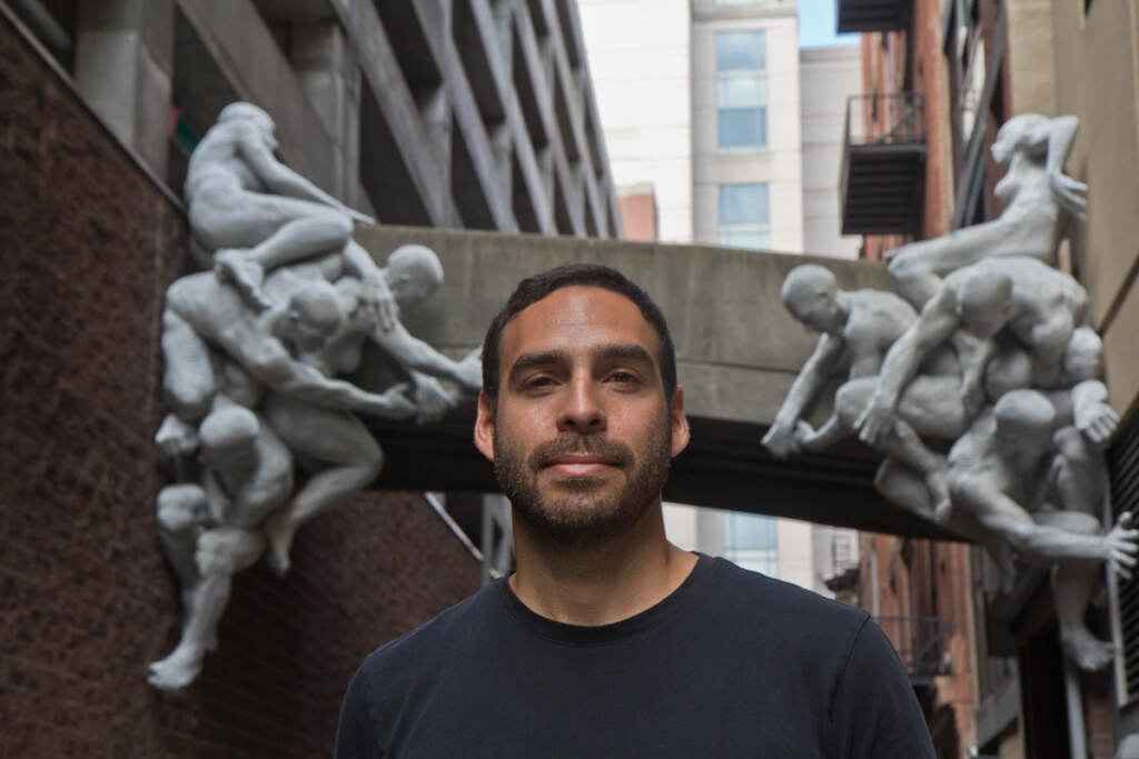 Artist Miguel Antonio Horn with his aluminum-plated sculpture