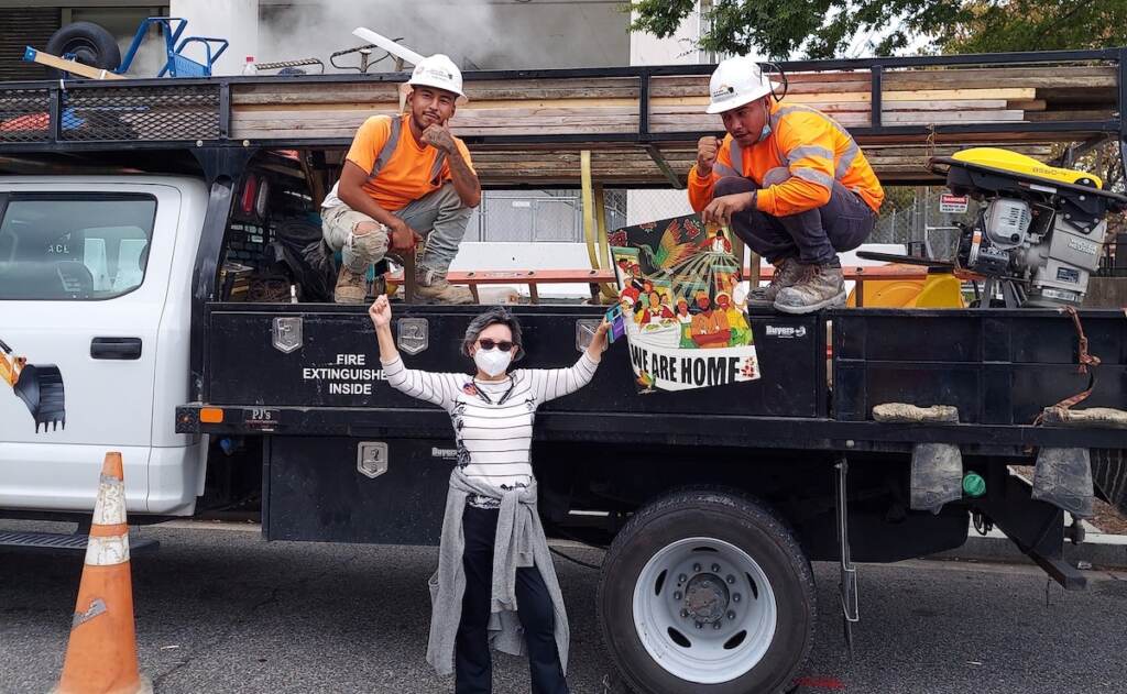 Charito Calvachi-Mateyko, who participated in Tuesday’s march in Washington, posed with two unidentified workers that day