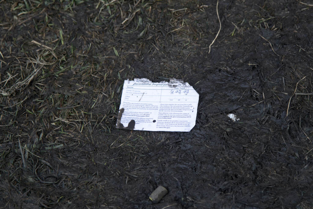 2021 Lollapalooza Music Festival – Day 2 A lost and muddy COVID-19 vaccine card is seen on the ground during day two of the Lollapalooza Music Festival