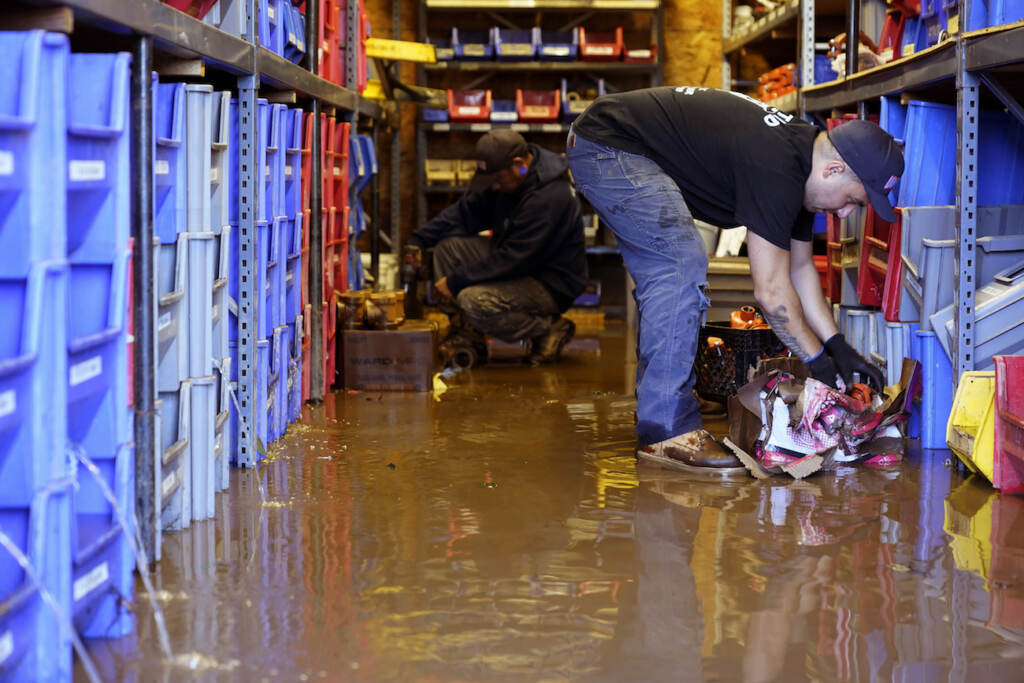 Tropical Weather Atlantic Louis Dearani, Jr., right, helps to clean up after his family business, United Automatic Fire Sprinkler, was flooded in Woodland Park, N.J., Thursday, Sept. 2, 2021. (AP Photo/Seth Wenig)