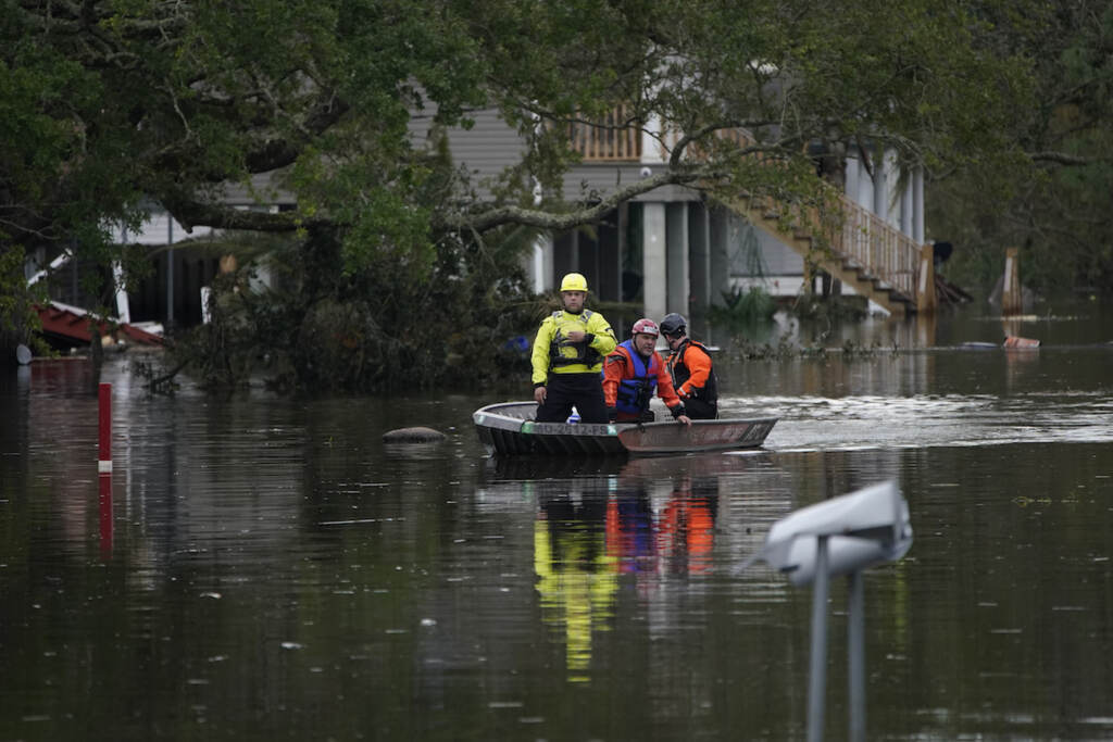 Philanthropy Hurricane Ida Animal rescue drive a boat down a flooded street