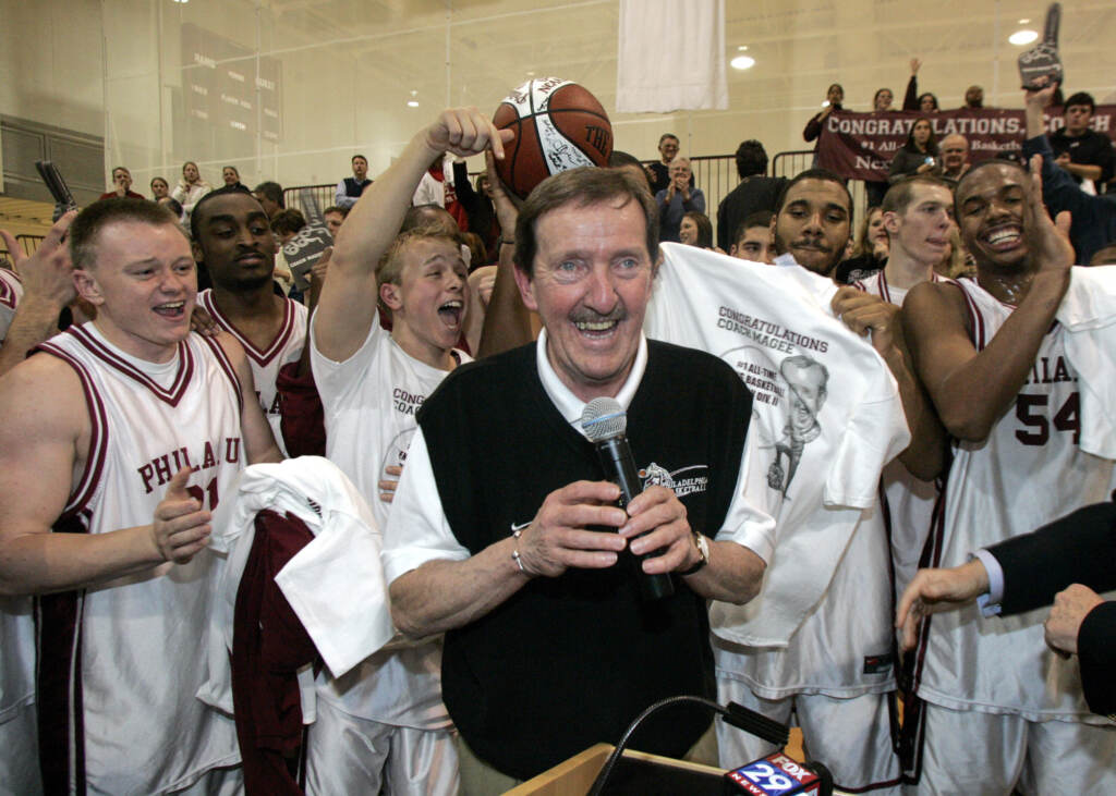 Herb Magee FILE - In this Feb. 1, 2007, file photo, Philadelphia University coach Herb Magee, center, celebrates his 829th career coaching victory, a new NCAA Division II record, with members of the team after they defeated Wilmington College, 65-60 in overtime, in an NCAA college basketball game in Philadelphia. Magee, who has 1,123 victories over a Basketball Hall of Fame career, will retire at the end of this season. (AP Photo/Tom Mihalek, File)
