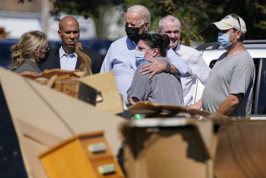 Joe Biden President Joe Biden hugs a person as he tours a neighborhood impacted by Hurricane Ida, Tuesday, Sept. 7, 2021, in Manville, N.J. Sen. Cory Booker, D-N.J., second from left, and New Jersey Gov. Phil Murphy, second from right, look on. (AP Photo/Evan Vucci)