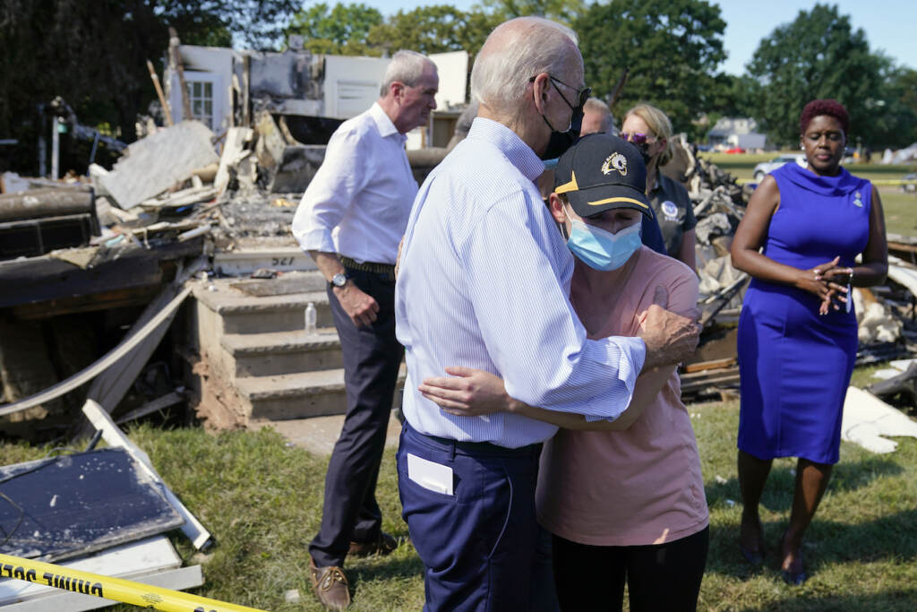 Joe Biden President Joe Biden talks with a person as he tours a neighborhood impacted by Hurricane Ida, Tuesday, Sept. 7, 2021, in Manville, N.J. New Jersey Gov. Phil Murphy, left, and Somerset County Commissioner President Shanel Robinson, right, look on. (AP Photo/Evan Vucci)
