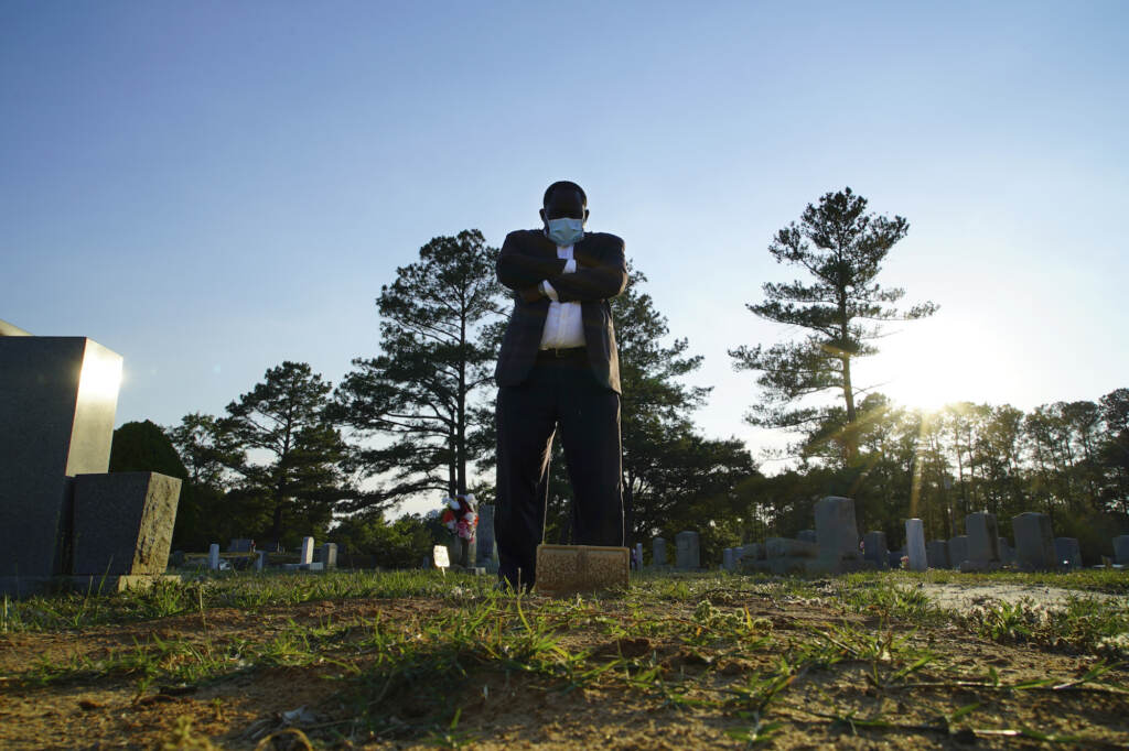 COVIDs Scars Burying Black Morticians Mortician stands at a grave.