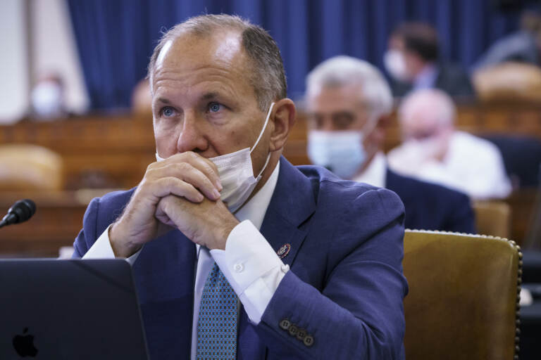 Rep. Lloyd Smucker sits with his mask below his nose at a House hearing