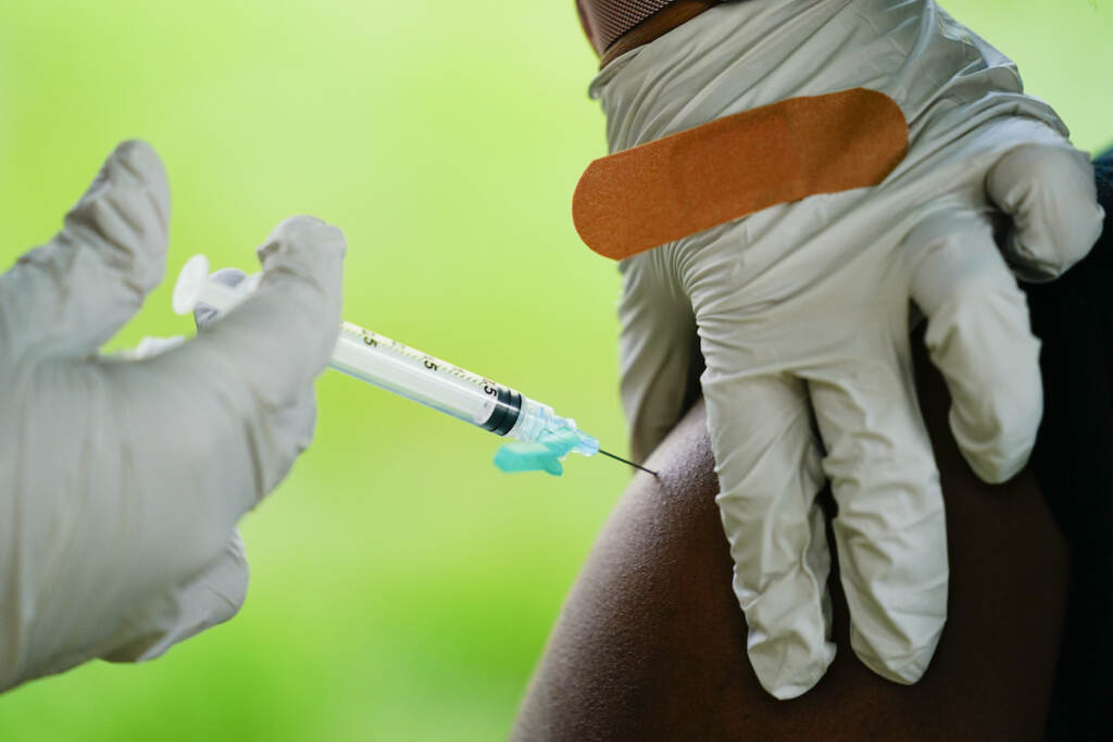 Virus Outbreak A health worker administers a dose of a Pfizer COVID-19 vaccine during a vaccination clinic at the Reading Area Community College in Reading, Pa., Tuesday, Sept. 14, 2021. (AP Photo/Matt Rourke)