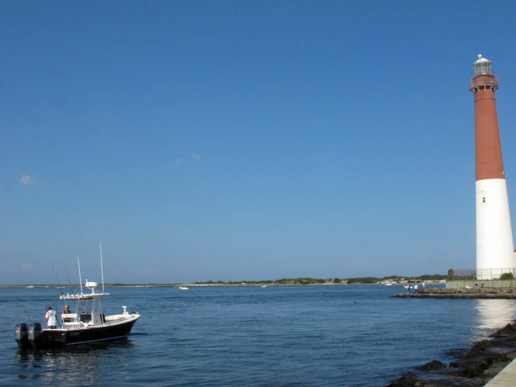 This Sept. 18, 2021 photo shows a boat near the Barnegat Inlet in Barnegat Light, N.J. The inlet is included in a $16 billion flood control plan that would build storm gates that could slam shut across the waterway, a proposal on which the government is seeking public input. (AP Photo/Wayne Parry)