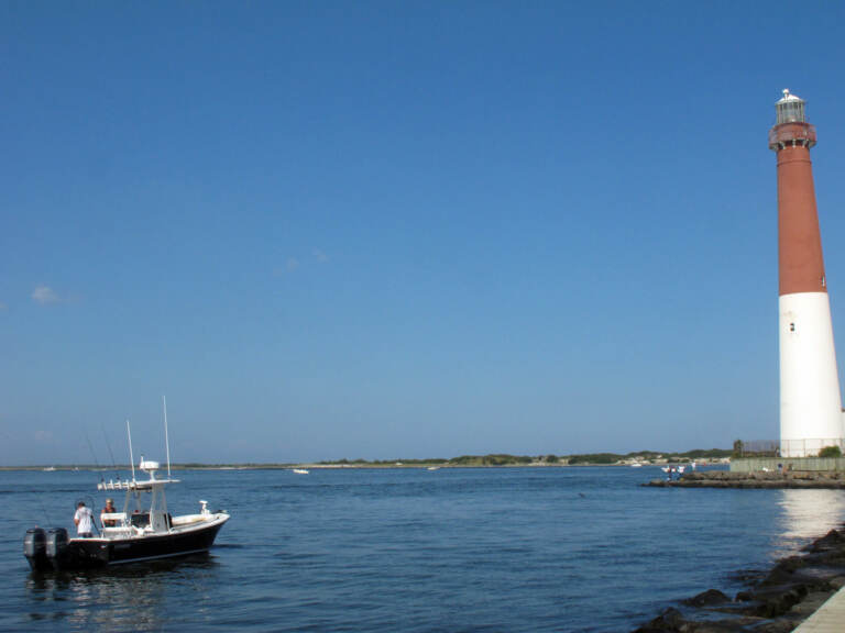 This Sept. 18, 2021 photo shows a boat near the Barnegat Inlet in Barnegat Light, N.J. The inlet is included in a $16 billion flood control plan that would build storm gates that could slam shut across the waterway, a proposal on which the government is seeking public input. (AP Photo/Wayne Parry)