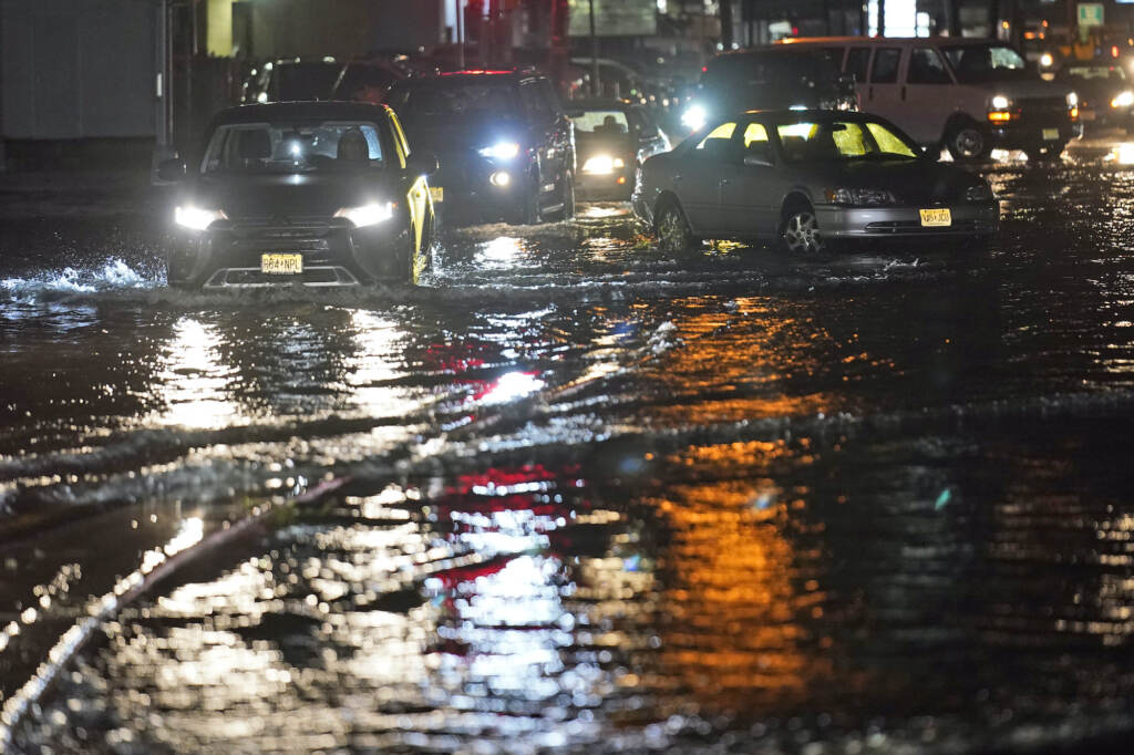Tropical Weather Atlantic Cars make their way through flooded streets and around abandoned cars in Teterboro