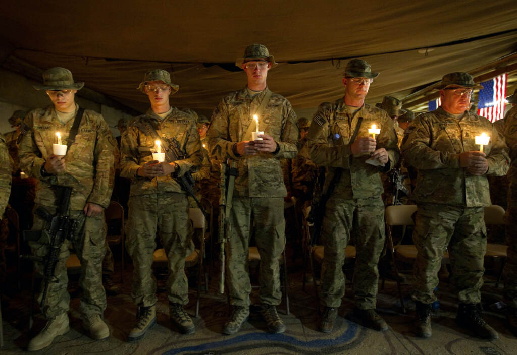 Sept 11 The Ways We Remember Soldiers hold up candles during a 9/11 anniversary event