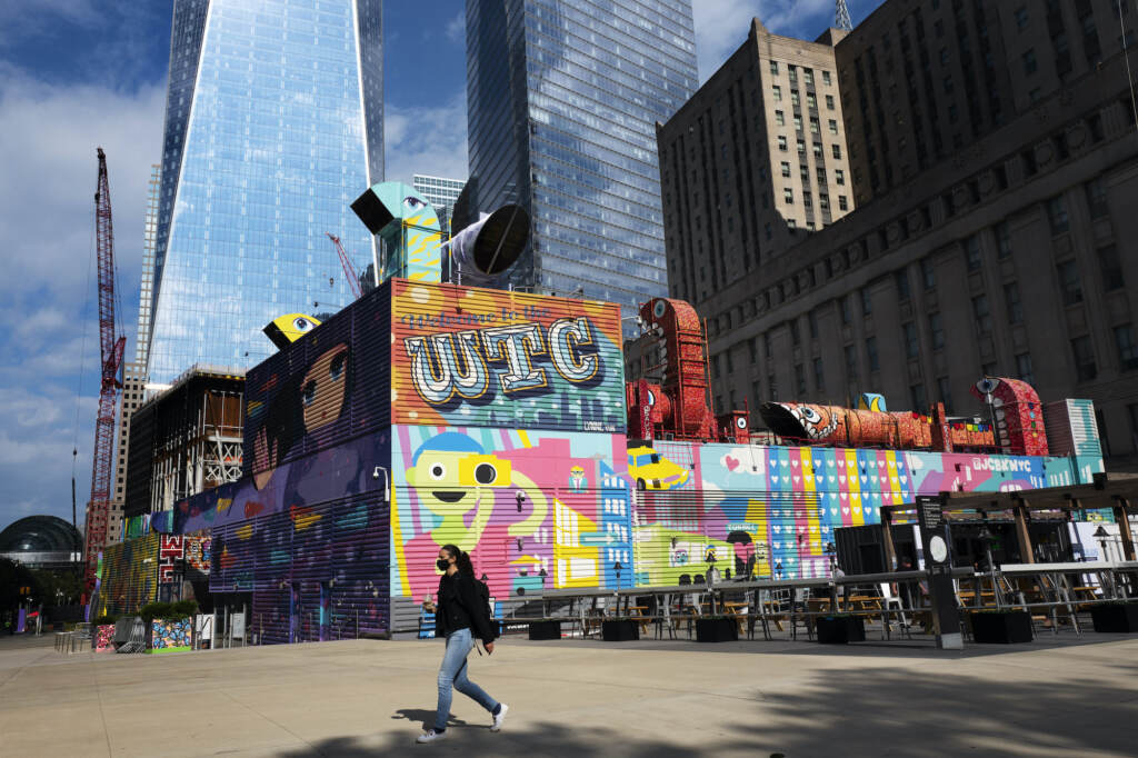 Sept 11 Ground Zero A woman walks by the colorful murals that surround the foundation for 2 World Trade Center