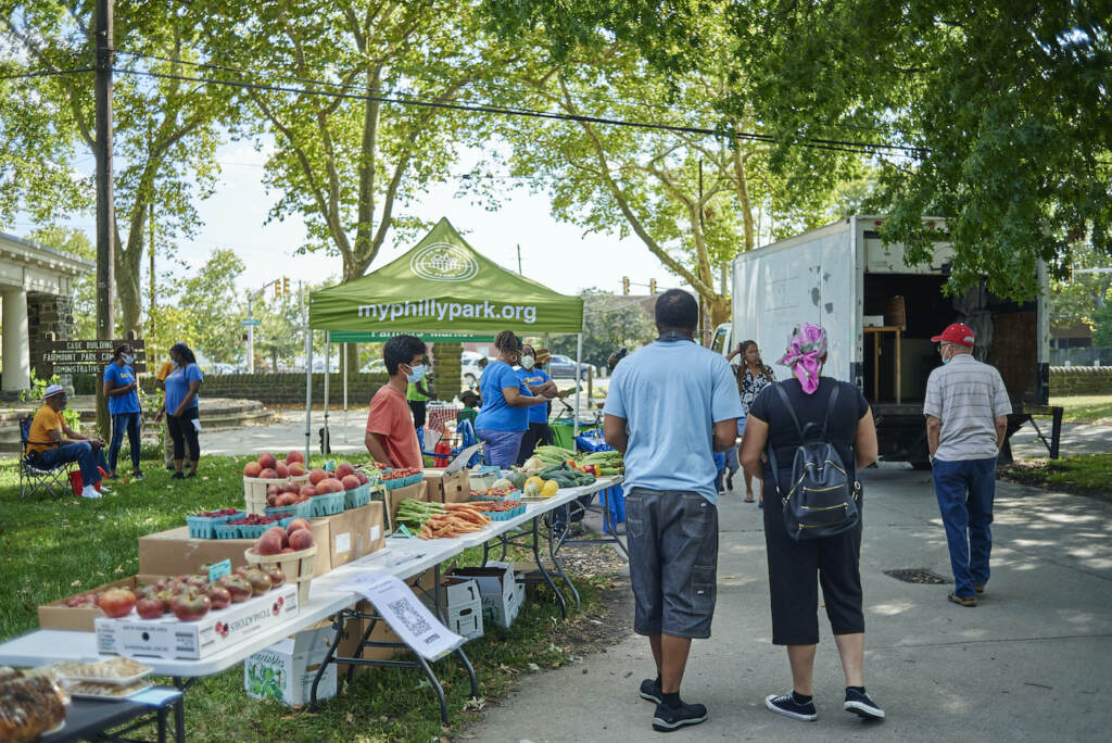 Week 5 of the East Parkside Farmers Market Visitors walk through the farmer's market at Fairmount Park