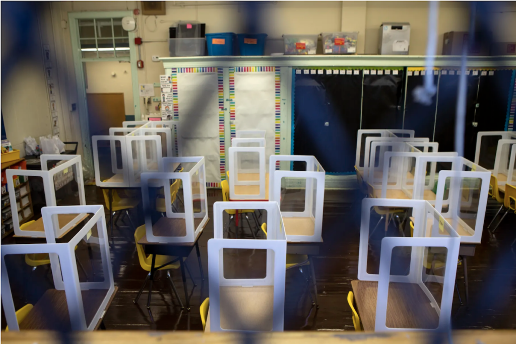 Screen Shot 2021-09-16 at 8.57.49 PM Spaced out desks are pictured through a fence