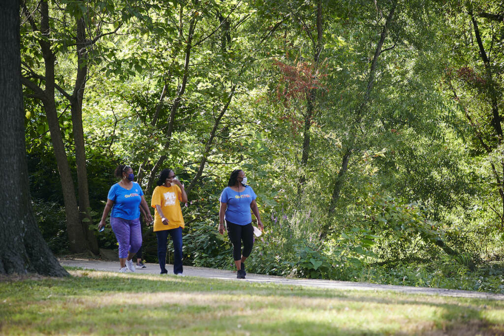 Week 5 of the East Parkside Farmers Market A group of people are pictured walking in a Philadelphia park
