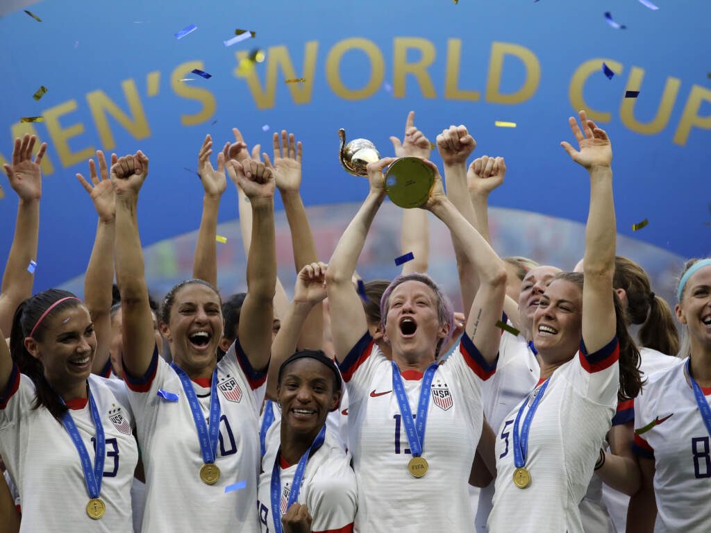 In this July 7, 2019, file photo, United States’ Megan Rapinoe lifts up a trophy after winning the Women’s World Cup final soccer match between U.S. and The Netherlands at the Stade de Lyon in Decines, outside Lyon, France. In this July 7, 2019, file photo, United States' Megan Rapinoe lifts up a trophy after winning the Women's World Cup final soccer match between U.S. and The Netherlands at the Stade de Lyon in Decines, outside Lyon, France. (Alessandra Tarantino/AP)