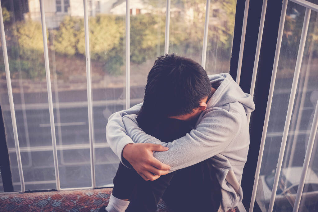 Depressed Young Preteen Teenage Boy Hugging His Knee , Children Noting an increase in children dealing with anxiety and depression, N.J. launched a new corner of its COVID-19 website dedicated to resources for young people. (sewcream/BigStock)
