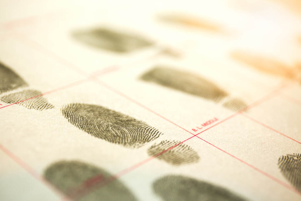 Forensic Concept Of Physiological Biometrics Criminal Record By A criminal record with suspect fingerprints with a lens flare and cinematic tone