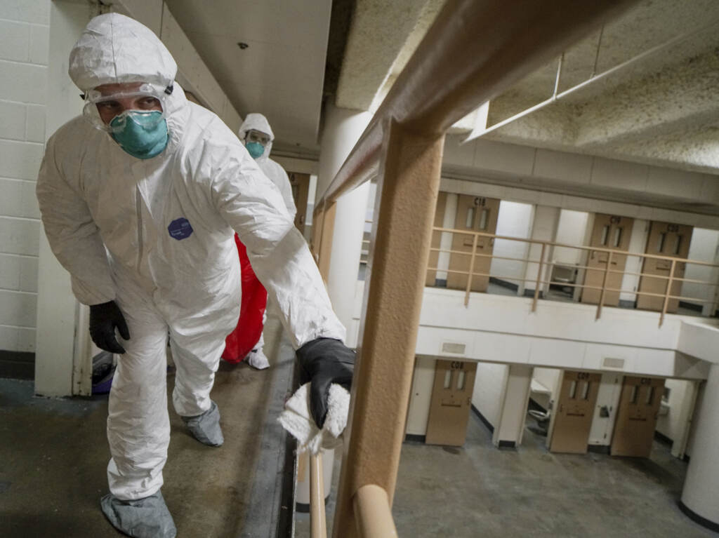 Inmates do a deep cleaning in a cell pod to prevent the spread of COVID-19 at the San Diego County Jail in April 2020. A new study says crowded jails may have contributed to millions of COVID-19 cases across the United States.
