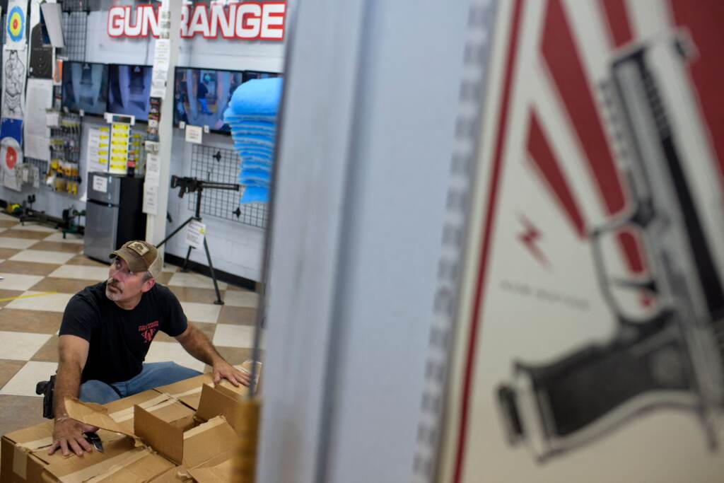Employee Curt Hubbard unloads a shipment of ammunition at Full Armor Firearms in Houston in June.