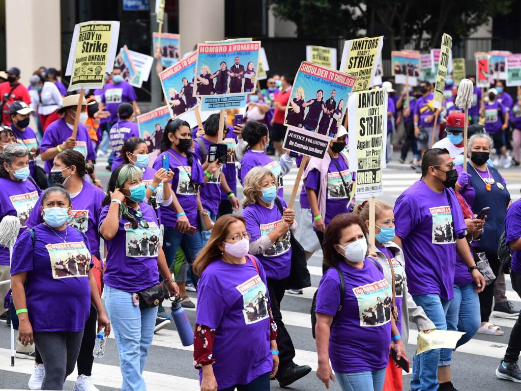 More than 1,000 janitors with the Service Employees International Union rally and march as their contracts expire ahead of a potential strike on Sept. 1, 2021, in Los Angeles. More than 1,000 janitors with the Service Employees International Union rally and march