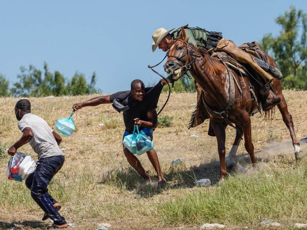 A U.S. Border Patrol agent on horseback tries to stop a Haitian migrant from entering an encampment on the banks of the Rio Grande near the Acuña Del Rio International Bridge in Del Rio, Texas. A U.S. Border Patrol agent on horseback tries to stop a Haitian migrant from entering an encampment on the banks of the Rio Grande