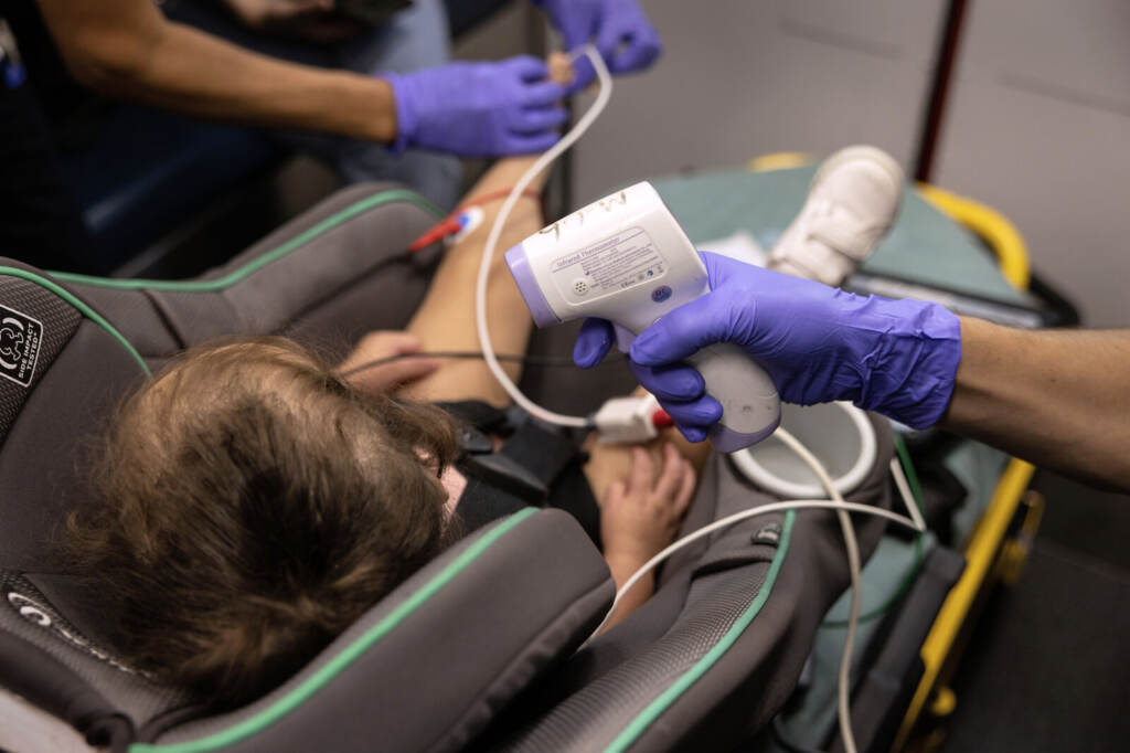 Houston EMS Attends To Suspected COVID-19 Patients Amid Surge In Delta Variant A medic takes the temperature of a 2-year-old sitting in a car seat