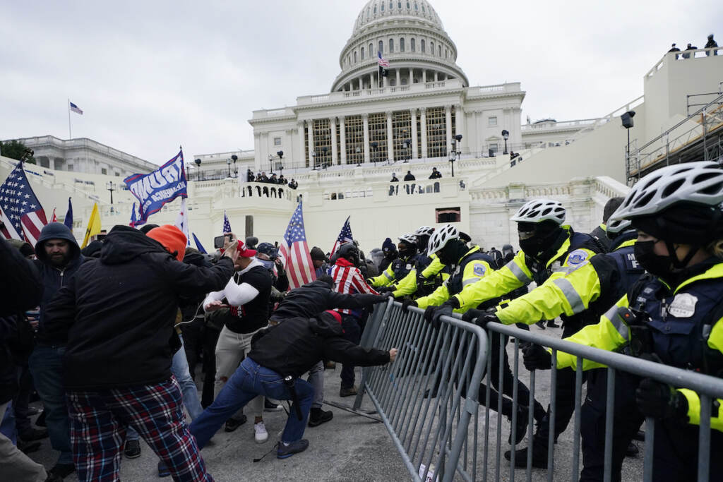 Capitol Breach Officers Discipline Trump supporters try to break through a police barrier, Wednesday, Jan. 6, 2021, at the Capitol in Washington. (AP Photo/Julio Cortez, File)