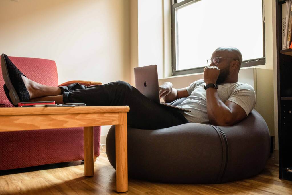 pexels-nappy-3360204-web A man sitting on a bean bag chair working from home