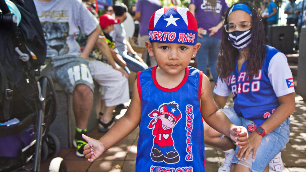 puertoricanparade-hispanicfiesta08crop Jovannie gestures while celebrating at Stroll the Harbor