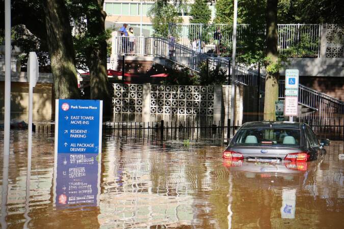 A car is swamped at Park Towne Place apartments off 22nd Street near the Vine Street Expressway. (Emma Lee/WHYY)