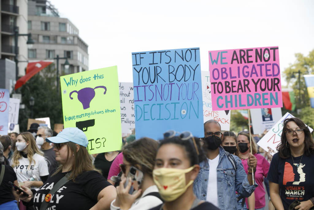 Signs are held up as marchers walk from the art museum to Philadelphia City Hall as part of an abortion rights rally held in Philadelphia, PA on Saturday, Oct. 2, 2021. Hundreds gather in Philadelphia as part of 